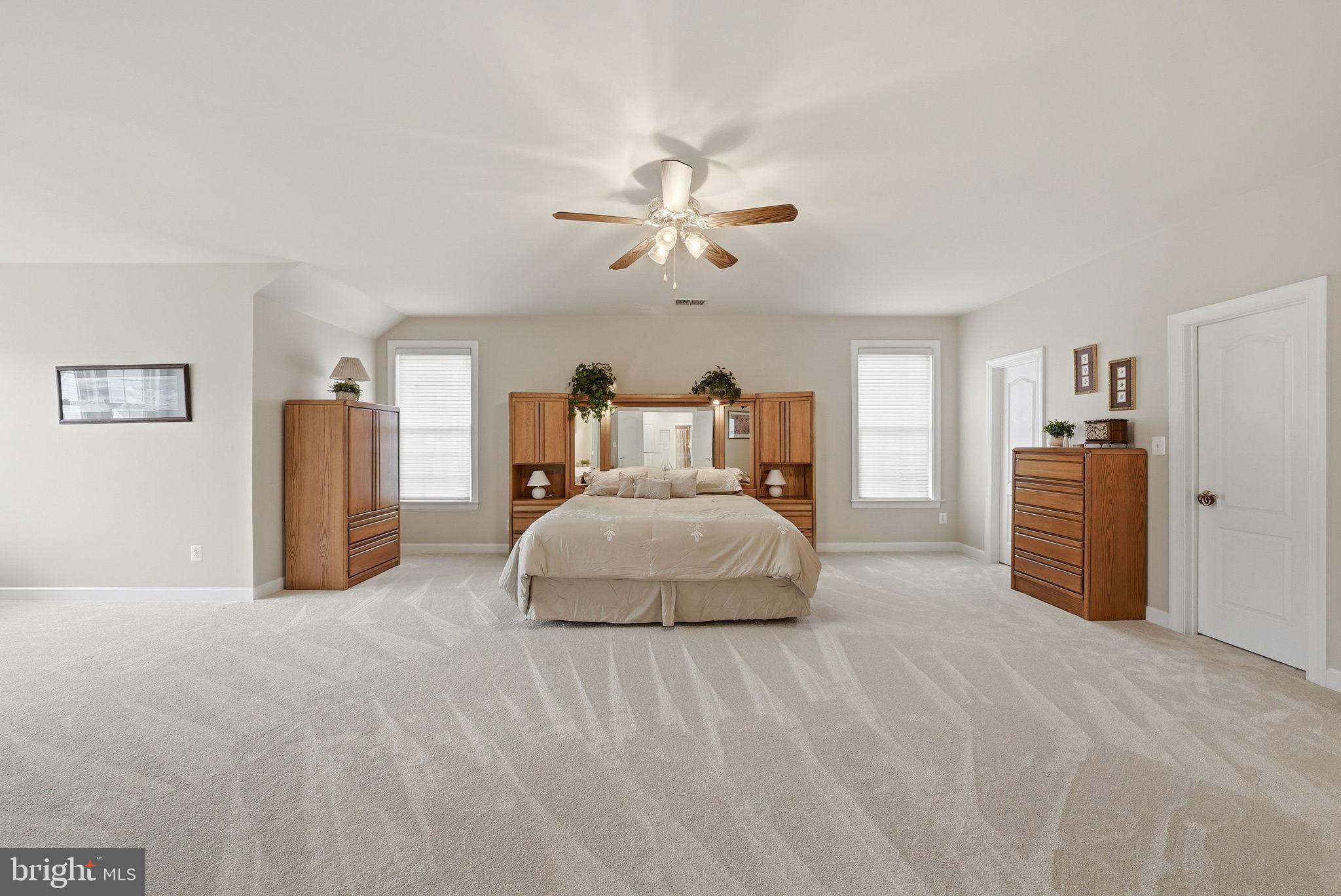 7820 Rose Garden Lane Springfield, VA 22153 - Photo 42 of 65 a bedroom with a large bed and a chandelier