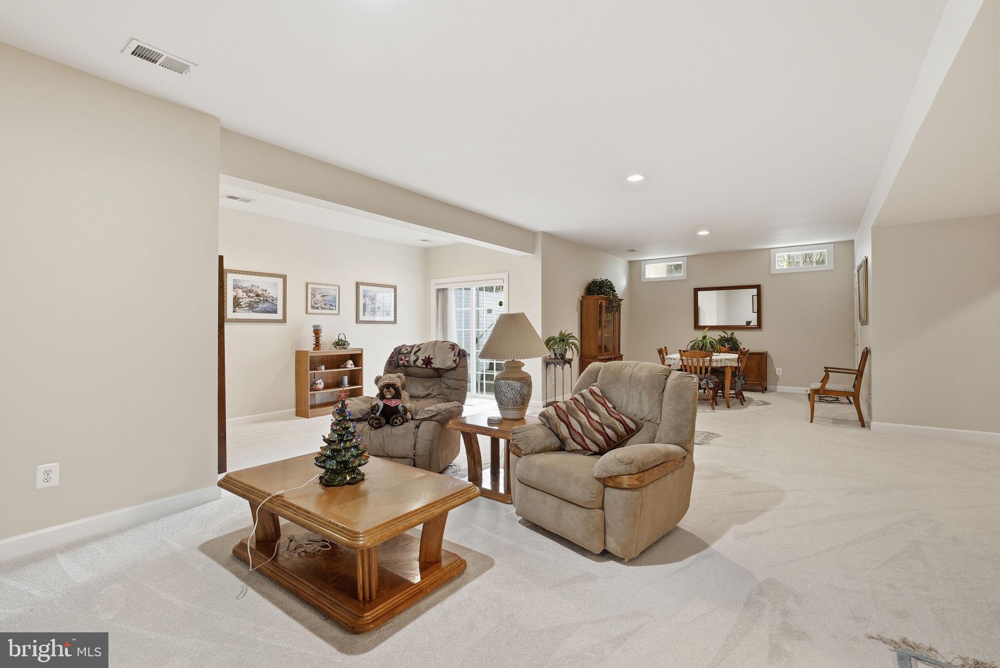 7820 Rose Garden Lane Springfield, VA 22153 - Photo 52 of 65 a living room with furniture gym equipment and a window