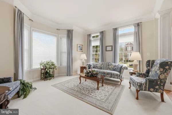 a dining room with furniture a chandelier and wooden floor