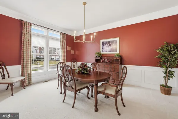 a view of a dining room with furniture and chandelier