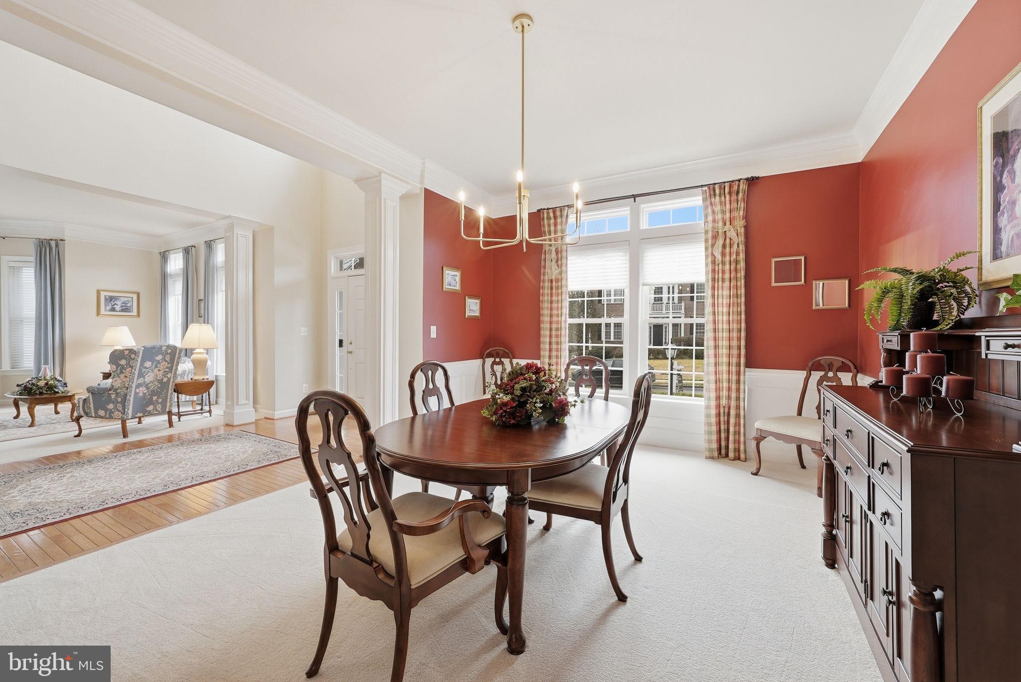 7820 Rose Garden Lane Springfield, VA 22153 - Photo 10 of 65 a dining room with furniture a chandelier and wooden floor