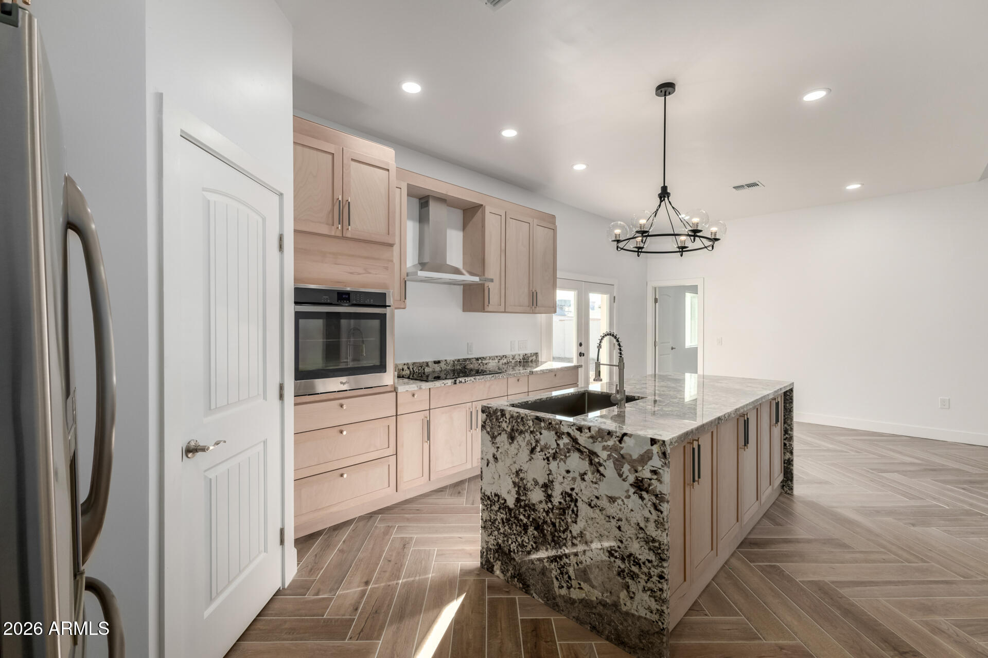 6345 West Grandview Road Glendale, AZ 85306 - Photo 14 of 36 a kitchen with stainless steel appliances kitchen island granite countertop a stove and refrigerator