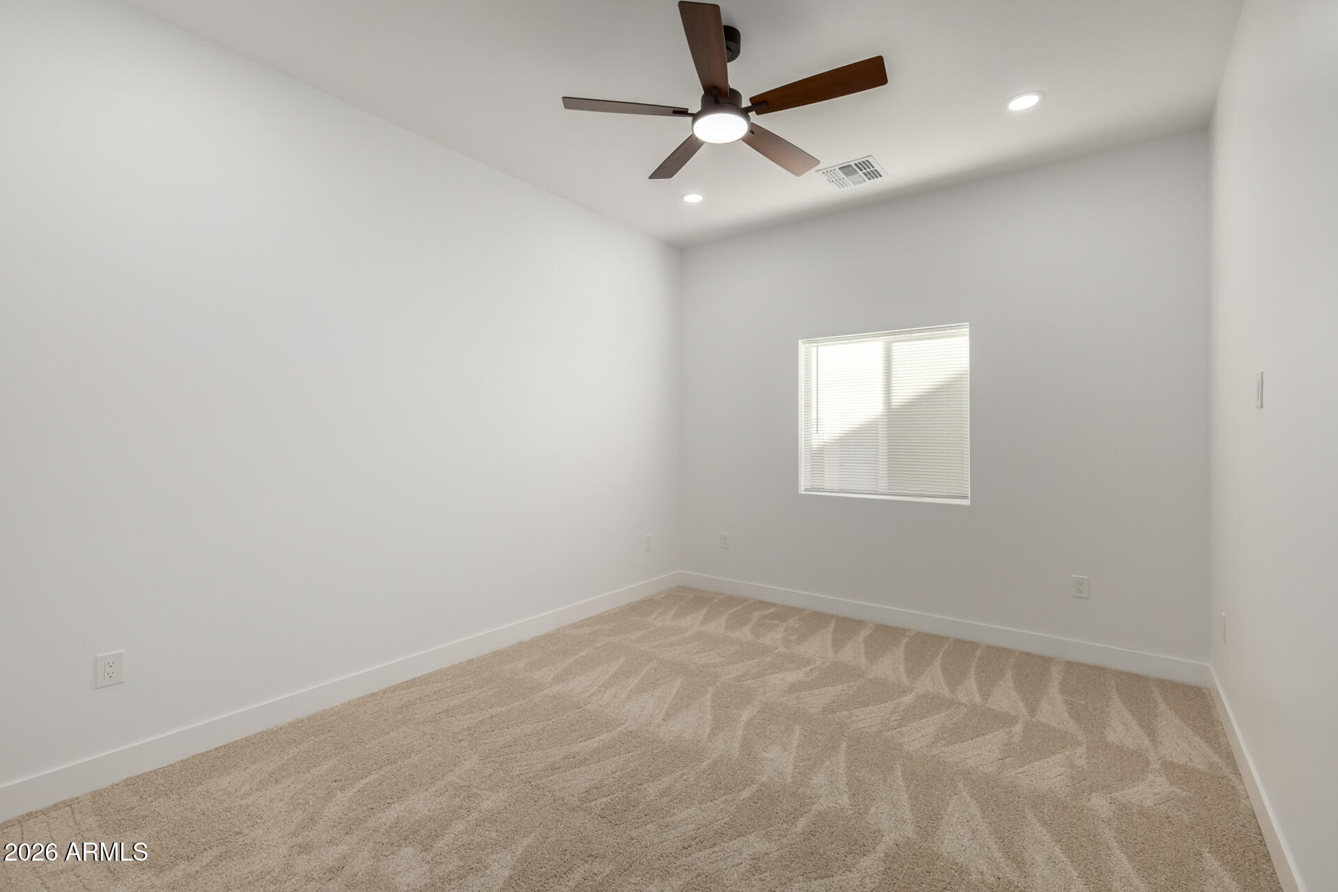 6345 West Grandview Road Glendale, AZ 85306 - Photo 19 of 36 an empty room with a window and a fan