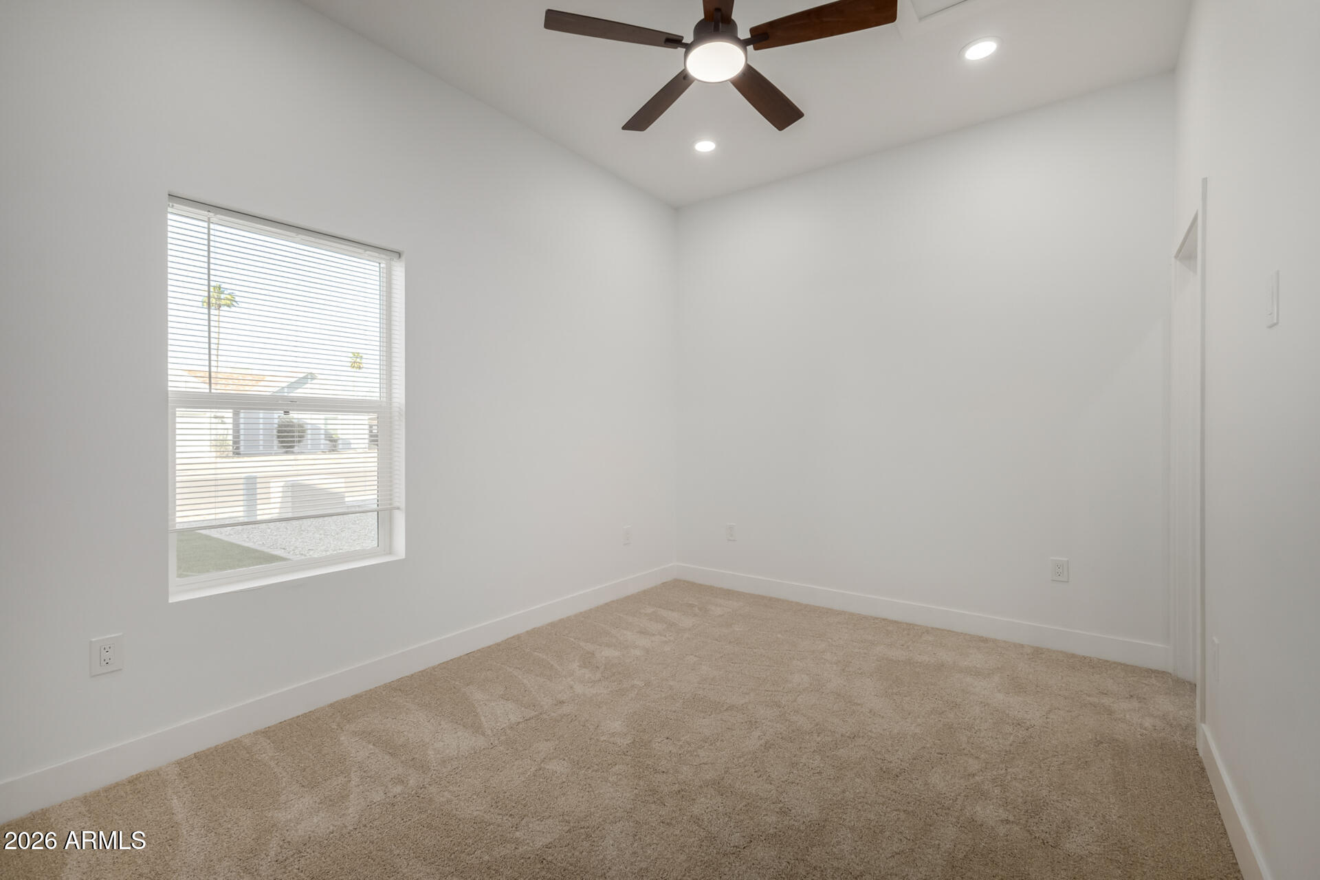 6345 West Grandview Road Glendale, AZ 85306 - Photo 25 of 36 an empty room with a window and a fan