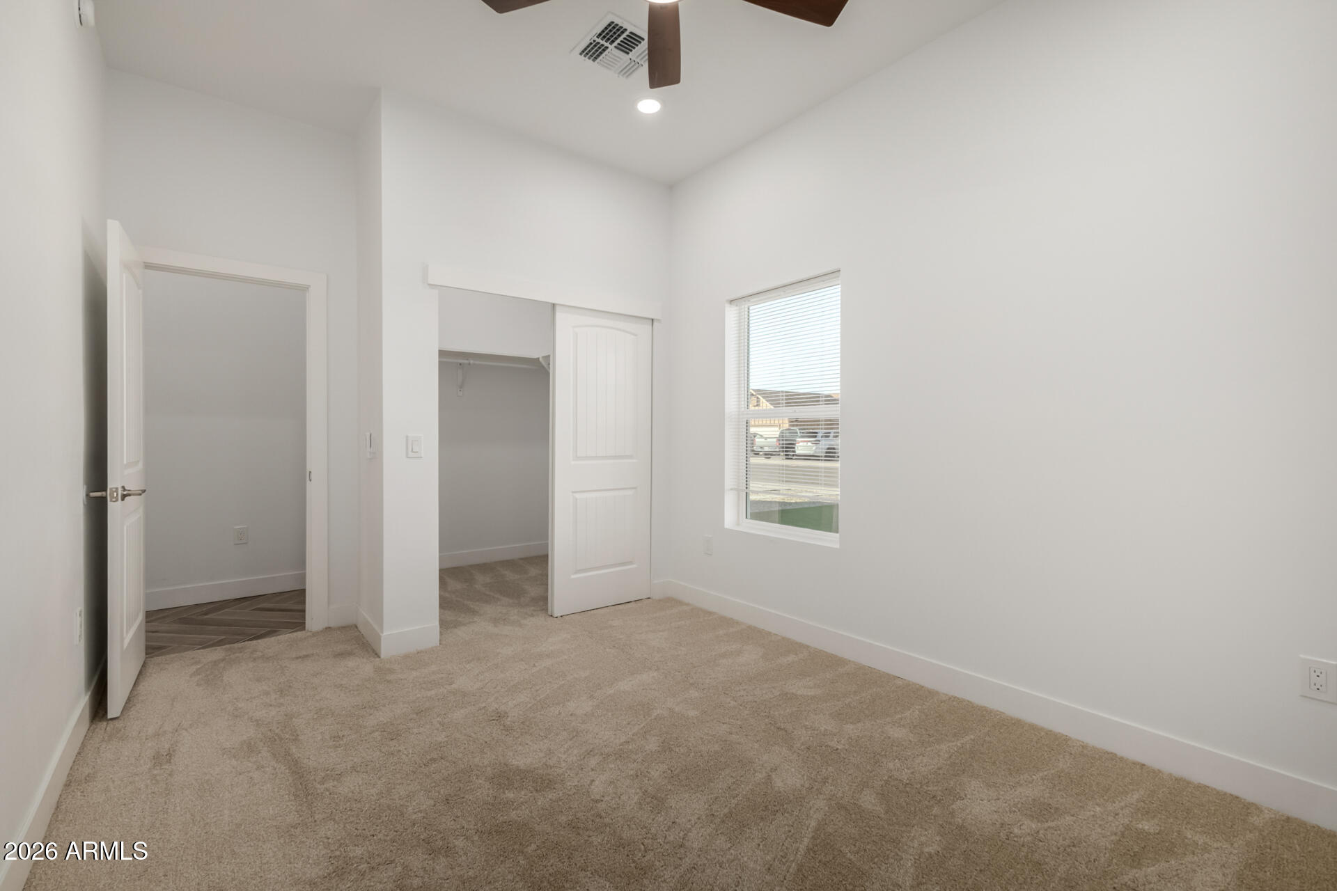 6345 West Grandview Road Glendale, AZ 85306 - Photo 26 of 36 an empty room with a ceiling fan and a window