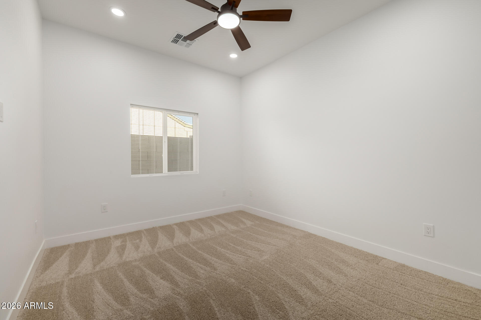6345 West Grandview Road Glendale, AZ 85306 - Photo 27 of 36 an empty room with a window and a fan