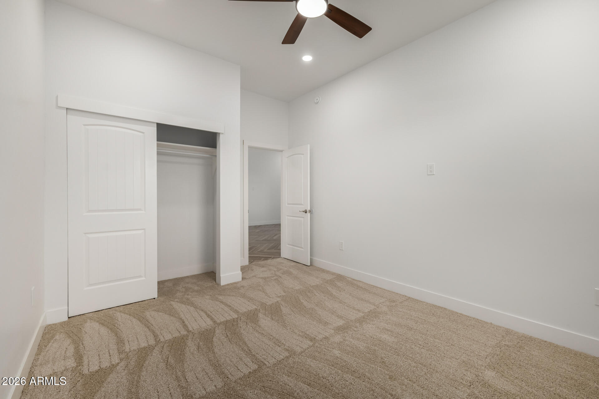 6345 West Grandview Road Glendale, AZ 85306 - Photo 28 of 36 an empty room with a ceiling fan and carpet