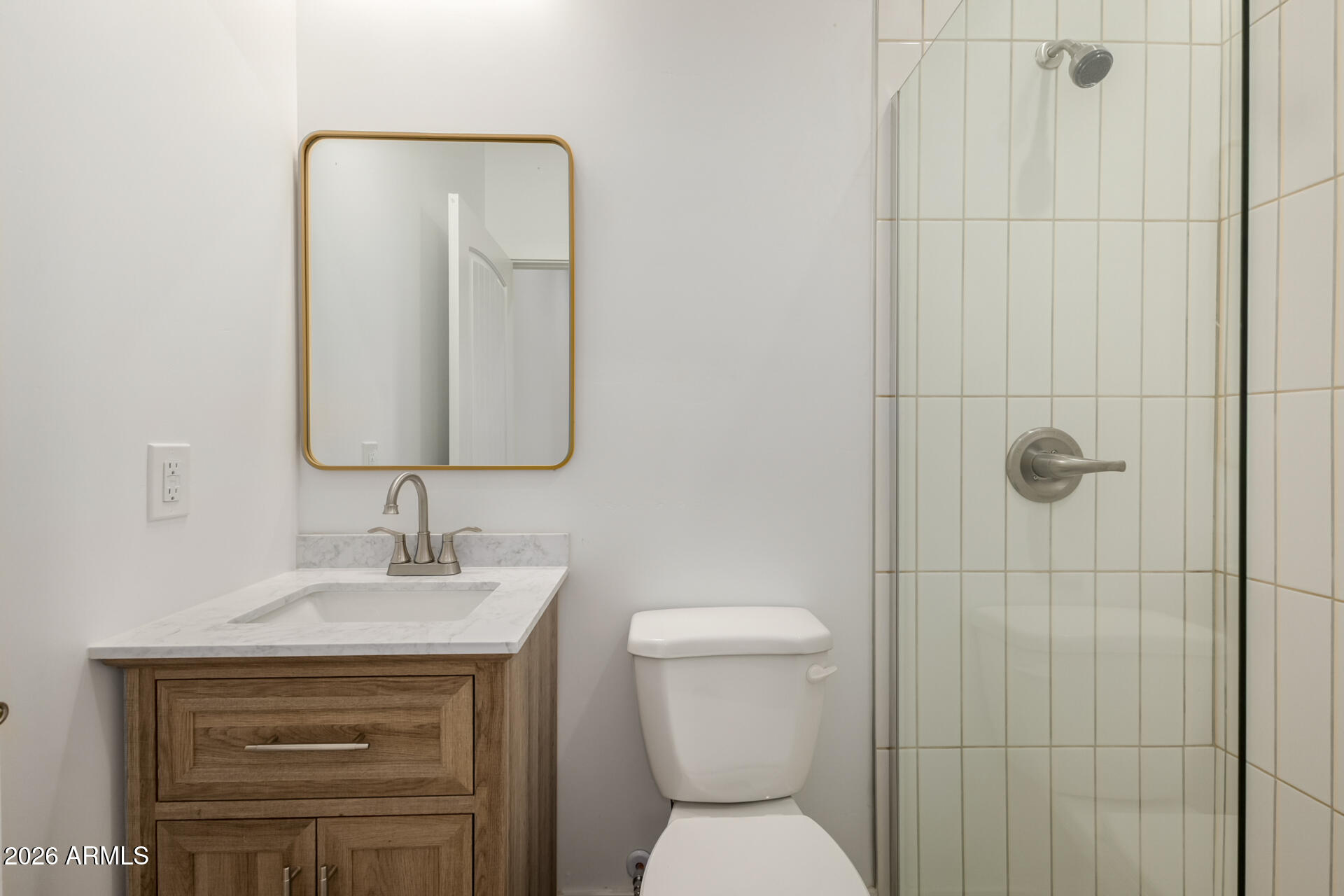 6345 West Grandview Road Glendale, AZ 85306 - Photo 29 of 36 a bathroom with a toilet sink vanity and mirror