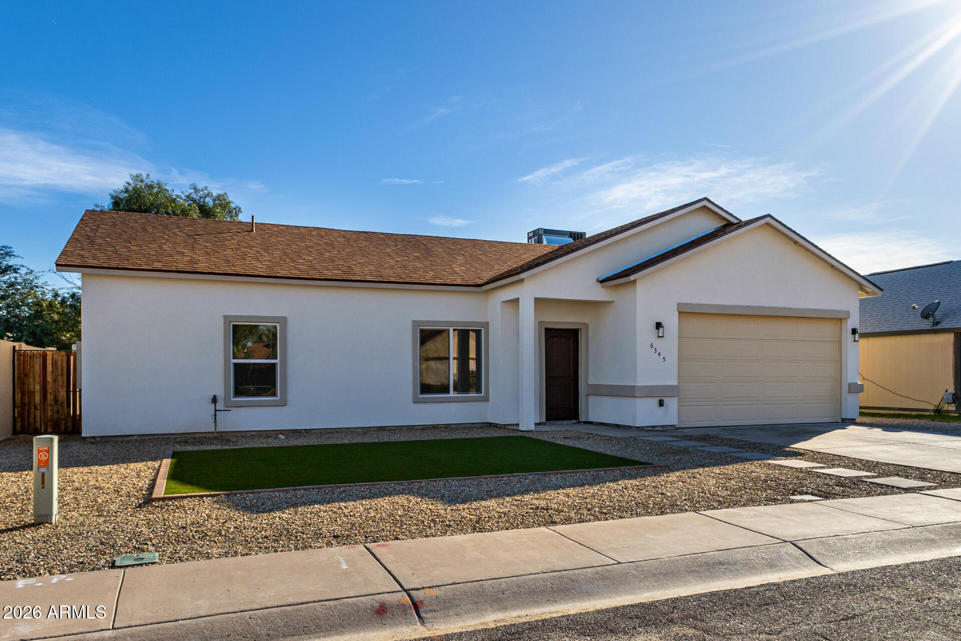 6345 West Grandview Road Glendale, AZ 85306 - Photo 3 of 36 a front view of a house with a yard and garage