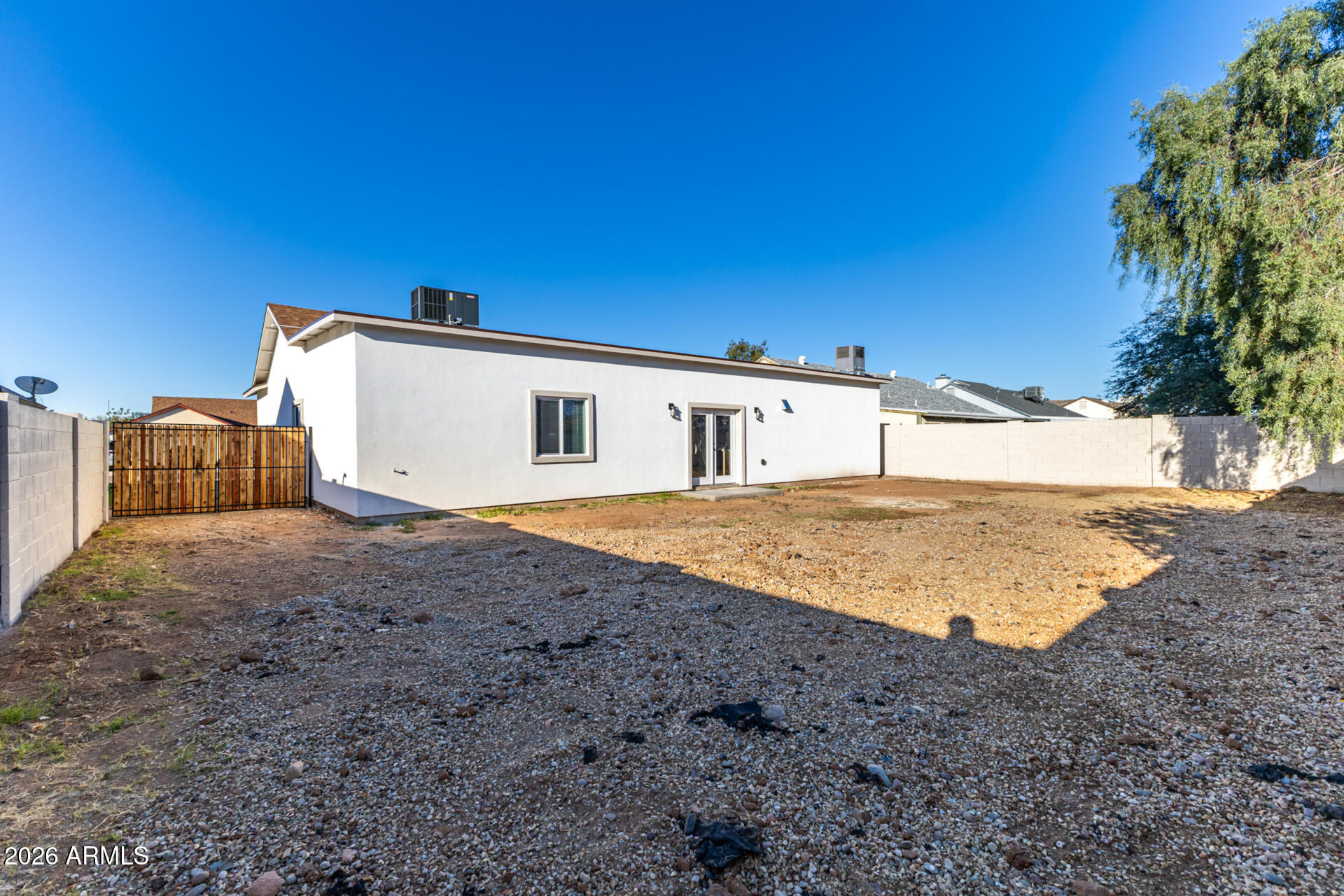 6345 West Grandview Road Glendale, AZ 85306 - Photo 33 of 36 a view of a house with backyard and a forest