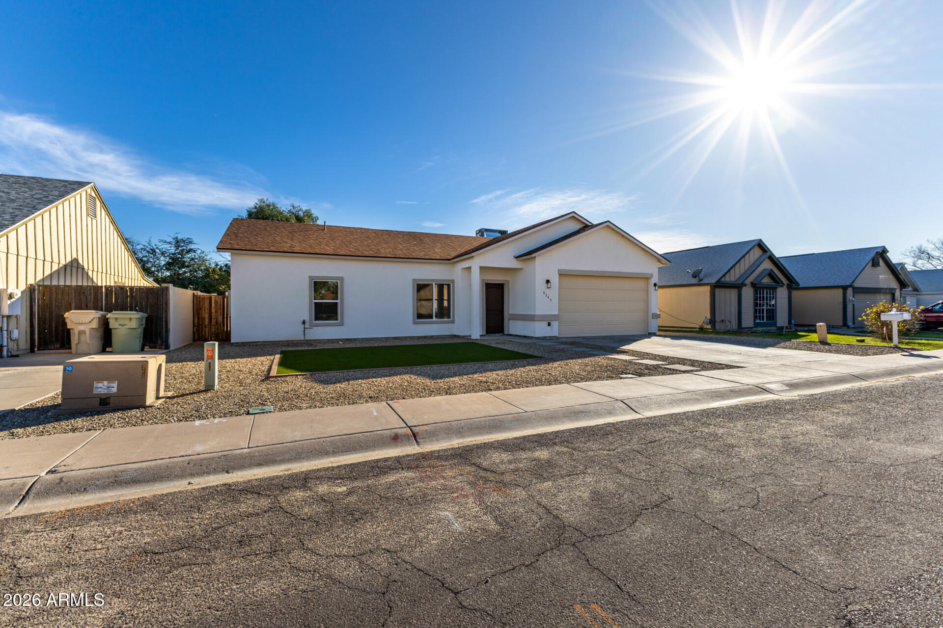 6345 West Grandview Road Glendale, AZ 85306 - Photo 4 of 36 a front view of a house with a yard and garage
