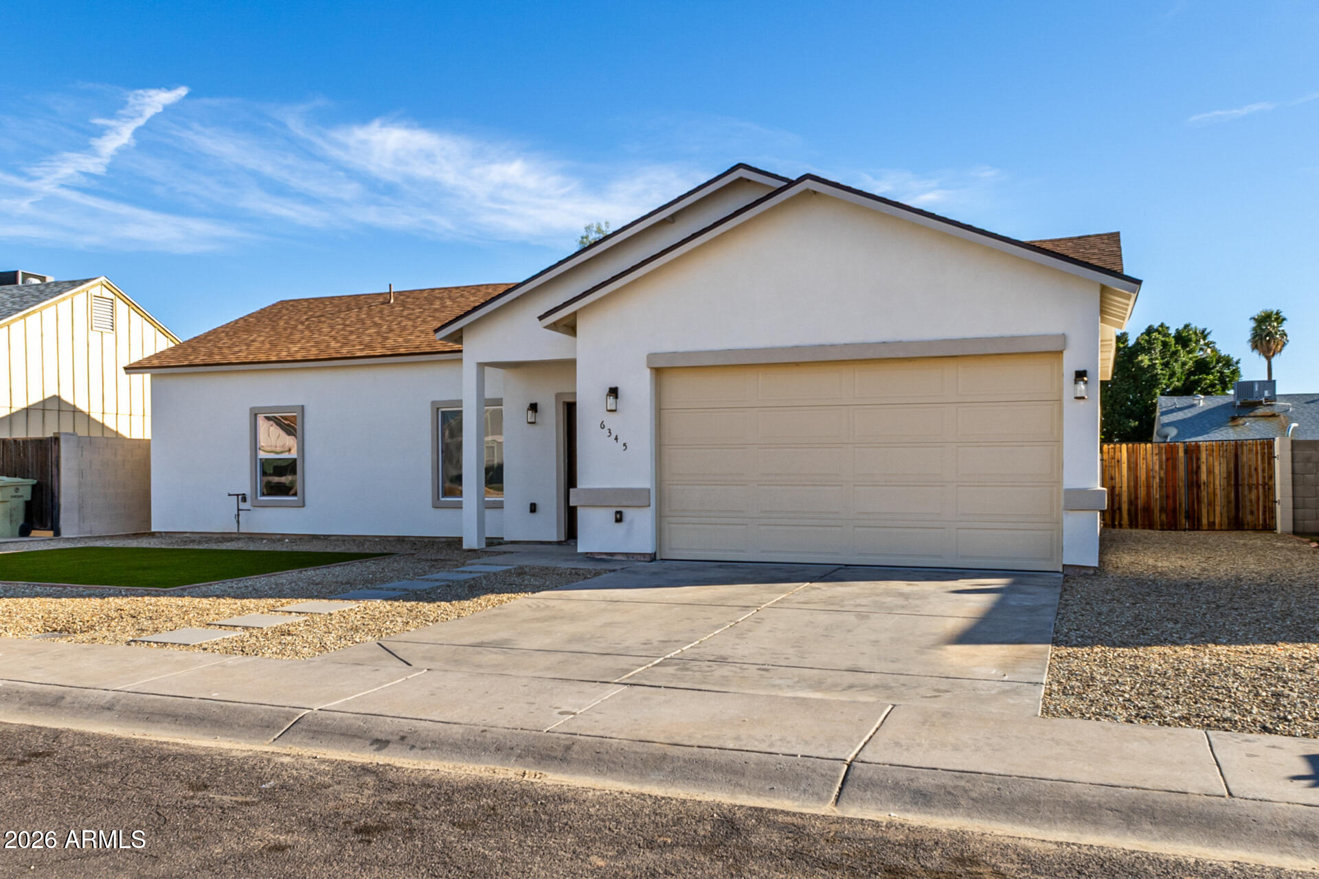 6345 West Grandview Road Glendale, AZ 85306 - Photo 5 of 36 a front view of a house with a yard and garage