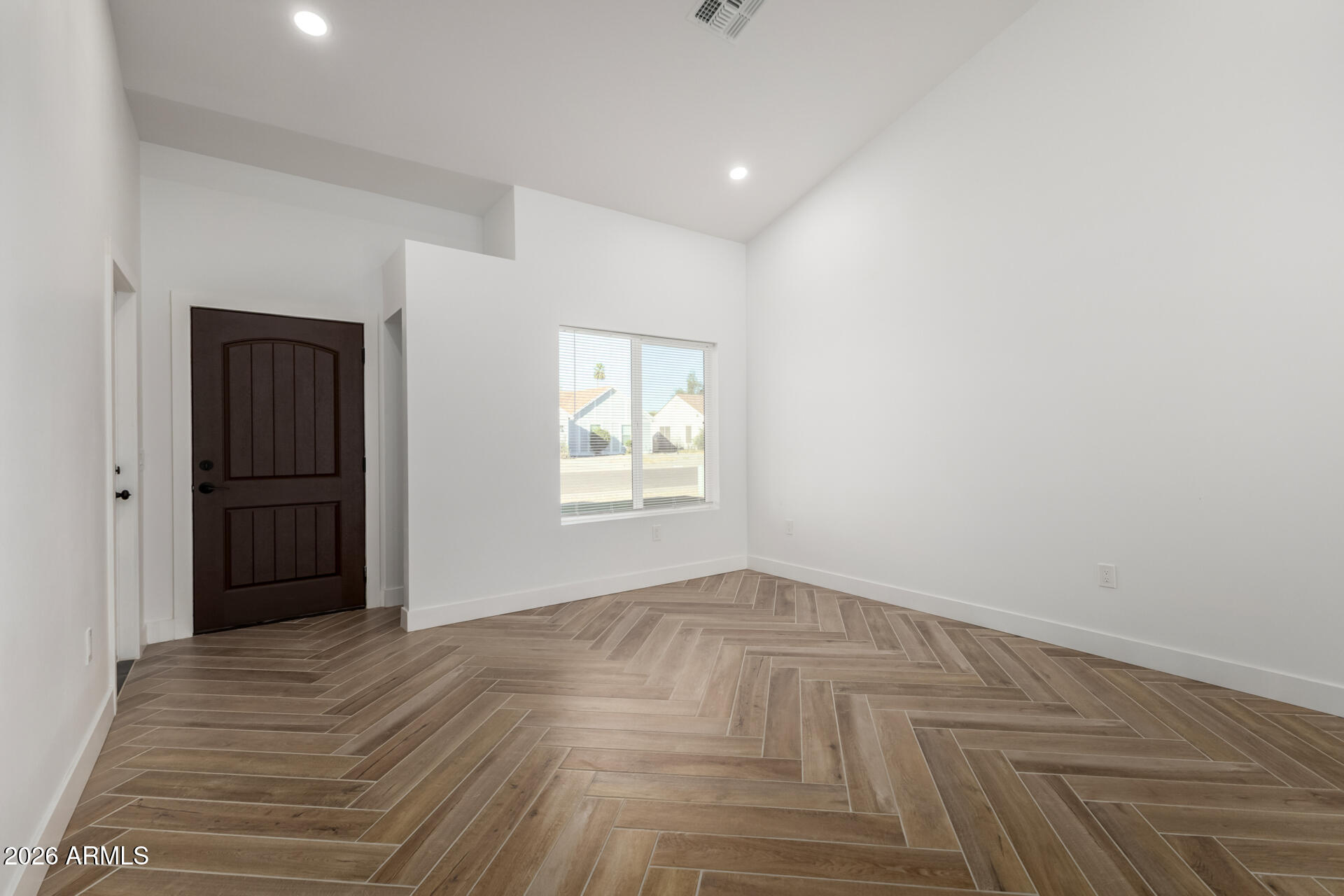 6345 West Grandview Road Glendale, AZ 85306 - Photo 9 of 36 a view of an empty room with wooden floor and a window