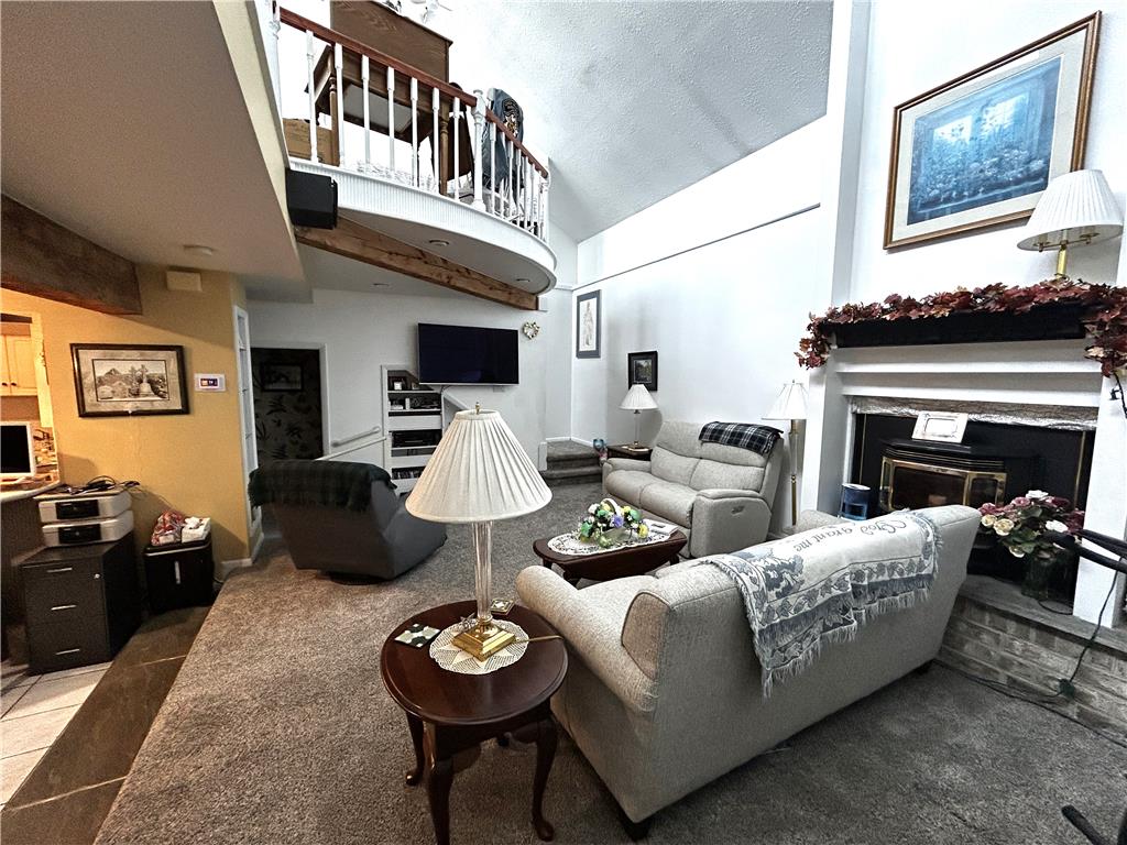 1214 Stanford Road Bethlehem, PA 18018 - Photo 31 of 63 A well-lit living area features a grand fireplace and an open mezzanine balcony.