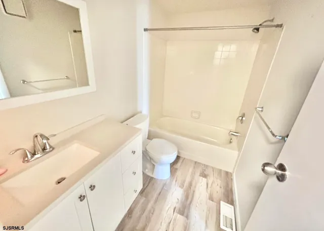 a bathroom with a sink a mirror and a shower