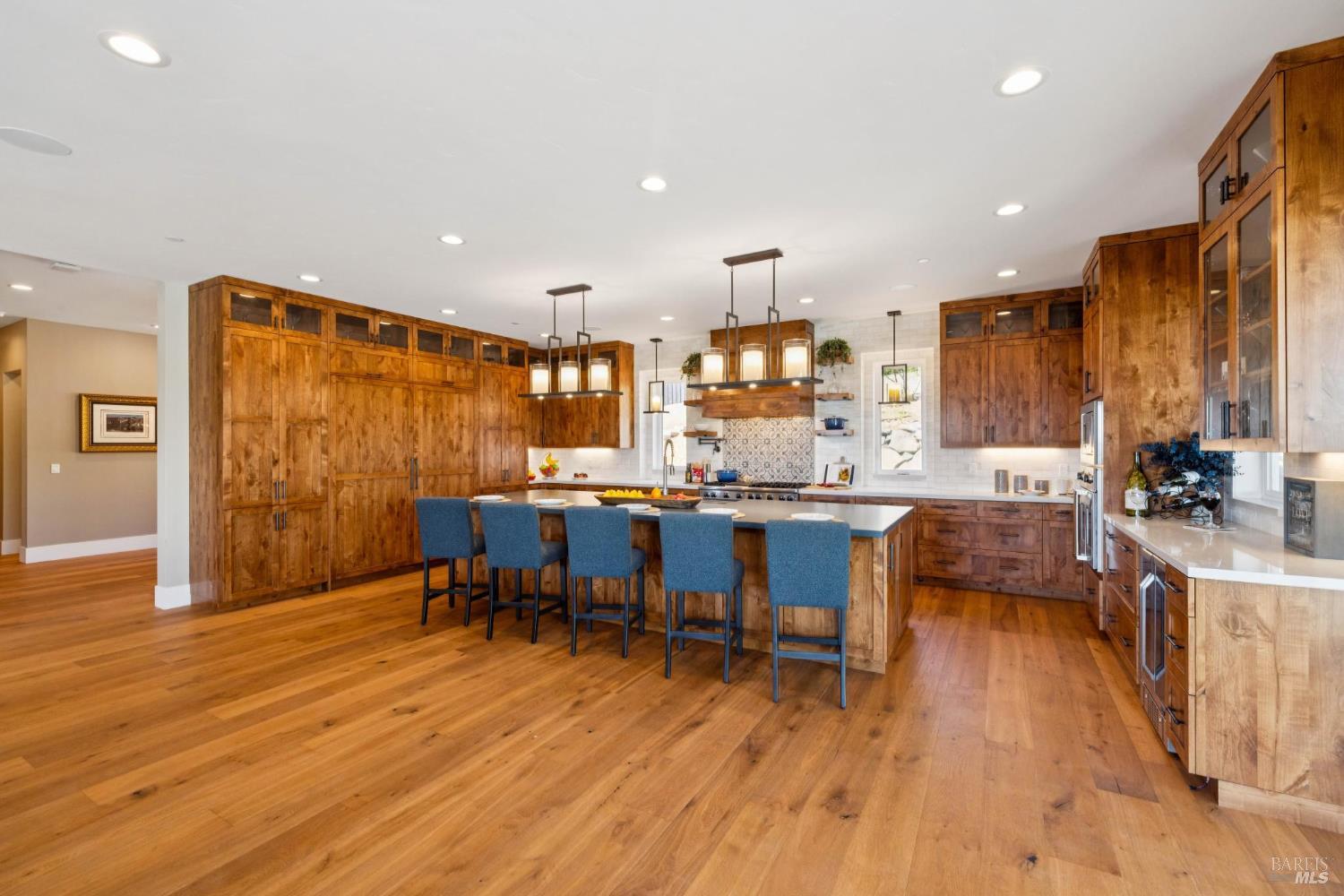 3882 Royal Manor Place Santa Rosa, CA 95404 - Photo 10 of 87 Cook for 2 or 20 in this chef's dream kitchen, featuring 48” Viking range with 6 burners + griddle and two ovens, a separate electric oven for the bakers, a large built-in Sub-Zero refrigerator, and a large built-in Sub-Zero freezer, pot filler, quartz counters, marble backsplash, Viking dishwasher, microwave, Kraus stainless steel sink with custom cutting board, drying rack and drain racks, beautiful customs alder cabinets, recessed lighting, surround sound and more.