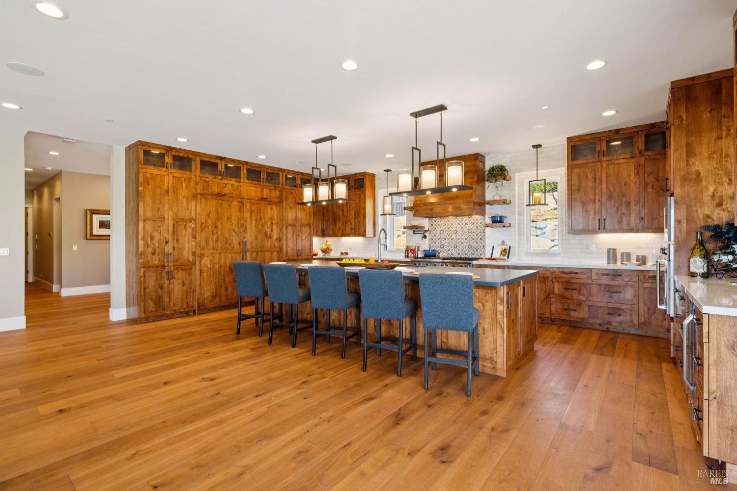 3882 Royal Manor Place Santa Rosa, CA 95404 - Photo 29 of 87 Cook for 2 or 20 in this chef's dream kitchen, featuring 48” Viking range with 6 burners + griddle and two ovens, a separate electric oven for the bakers, a large built-in Sub-Zero refrigerator, and a large built-in Sub-Zero freezer, pot filler, quartz counters, marble backsplash, Viking dishwasher, microwave, Kraus stainless steel sink with custom cutting board, drying rack and drain racks, beautiful customs alder cabinets, recessed lighting, surround sound and more.