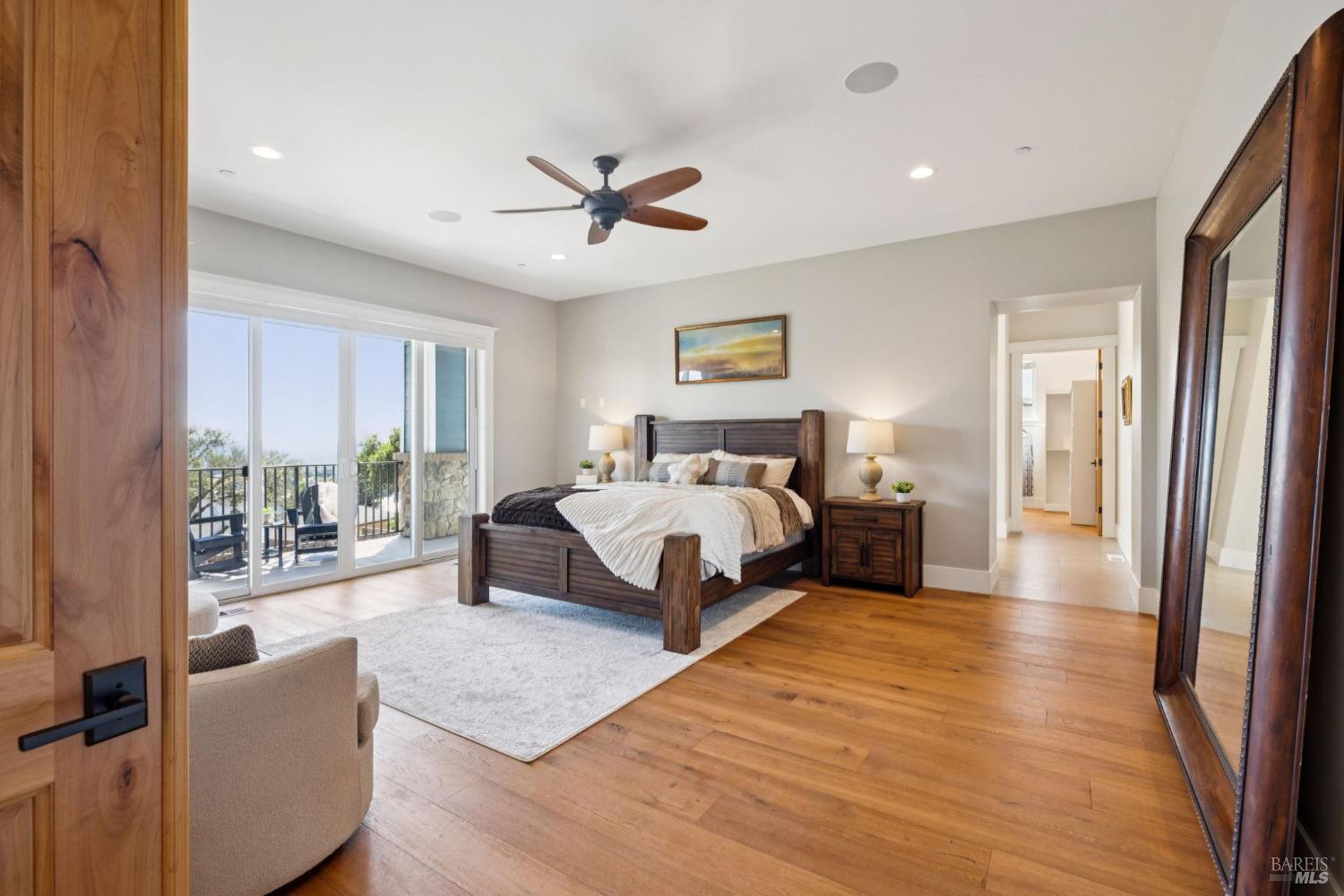 3882 Royal Manor Place Santa Rosa, CA 95404 - Photo 33 of 87 Spacious Main Level Primary Suite with balcony overlooking the city of Santa Rosa and the Sonoma Mountains. This suite features, hardwood floors, surround sound, recessed lighting, ceiling fan, dual sinks, walk in shower with dual shower heads, large jetted soaking tub, walk-in closet large doorways and openings for accessibility and more.