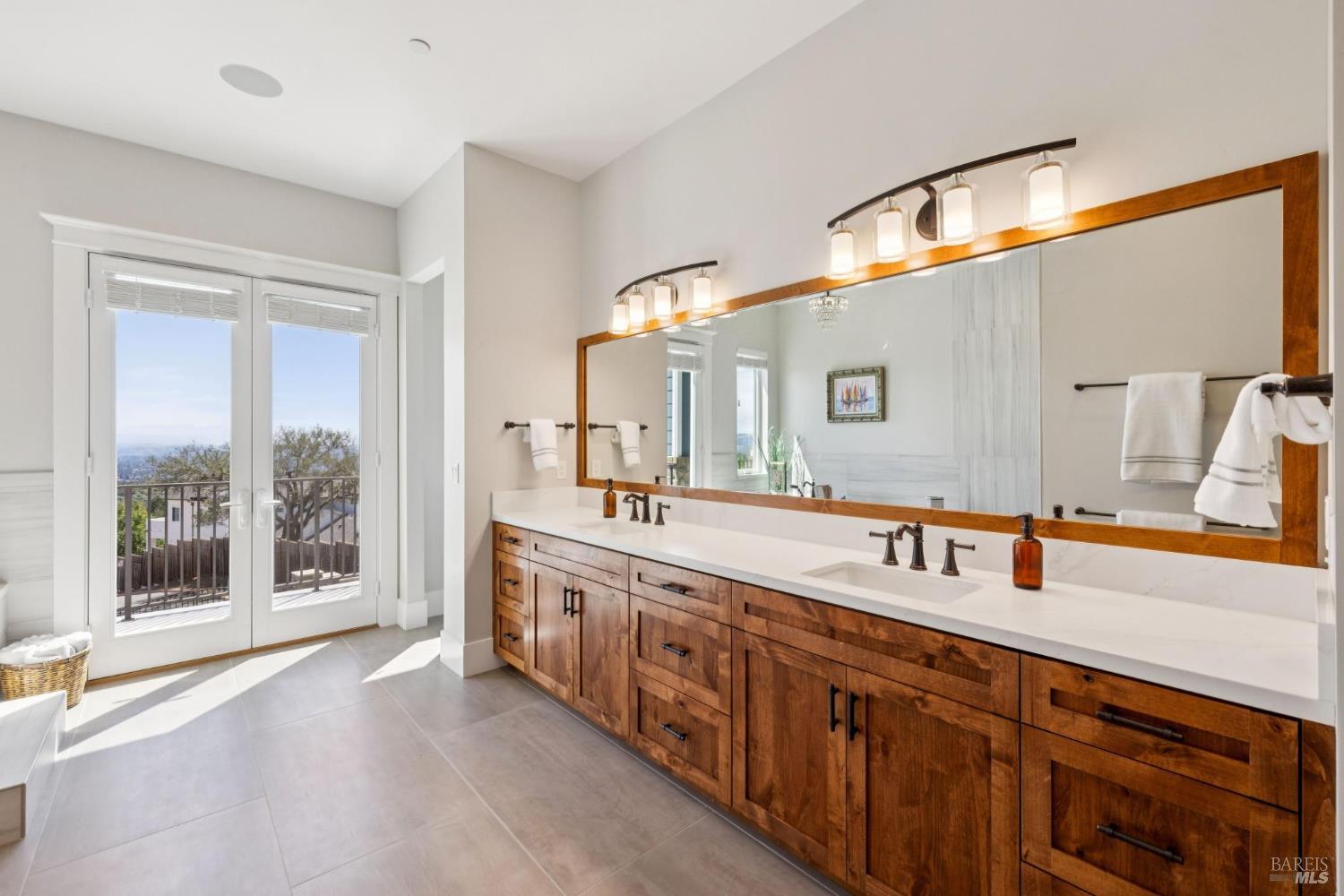 3882 Royal Manor Place Santa Rosa, CA 95404 - Photo 35 of 87 Spacious Main Level Primary Suite with balcony overlooking the city of Santa Rosa and the Sonoma Mountains. This suite features, hardwood floors, surround sound, recessed lighting, ceiling fan, dual sinks, walk in shower with dual shower heads, large jetted soaking tub, walk-in closet large doorways and openings for accessibility and more.