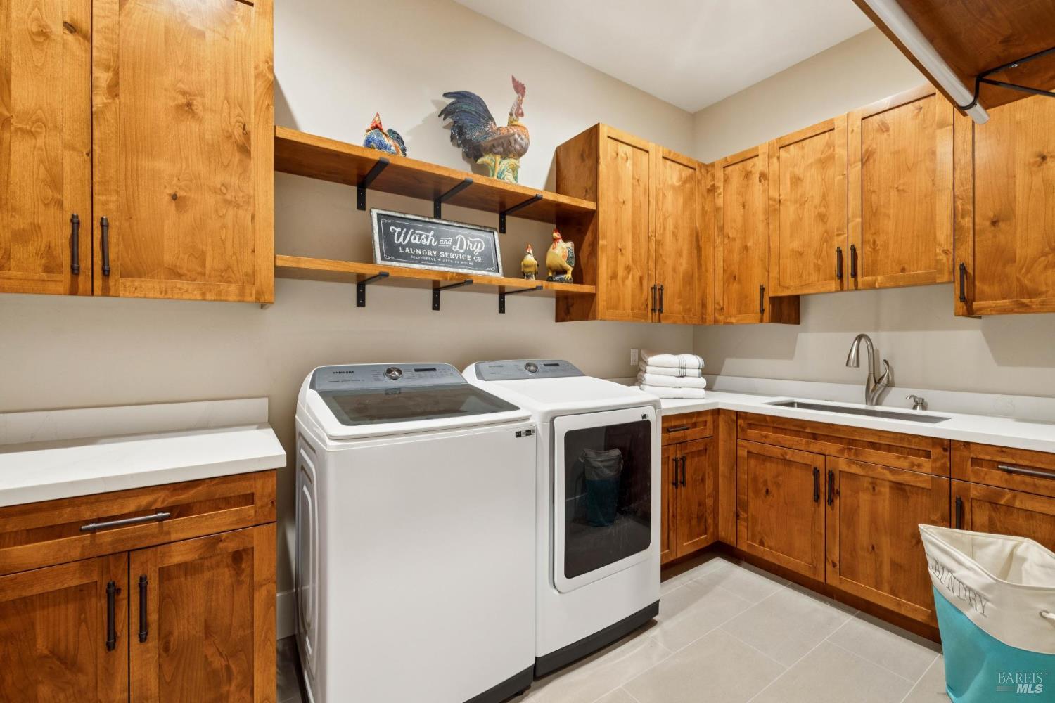 3882 Royal Manor Place Santa Rosa, CA 95404 - Photo 42 of 87 The large laundry room is at the end of the hallway near the 3 car garage. Filled with plenty of cabinet space, Elkay sink, and white quartz counters.