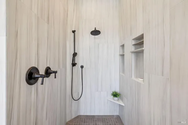 a bathroom with double vanity sinks granite vanity and a mirror