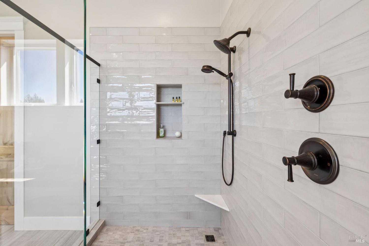 3882 Royal Manor Place Santa Rosa, CA 95404 - Photo 53 of 87 Upstairs primary full bathroom boasts a glass door shower with dual shower heads, a dual pane window, oil rubbed bronze Moen fixtures.