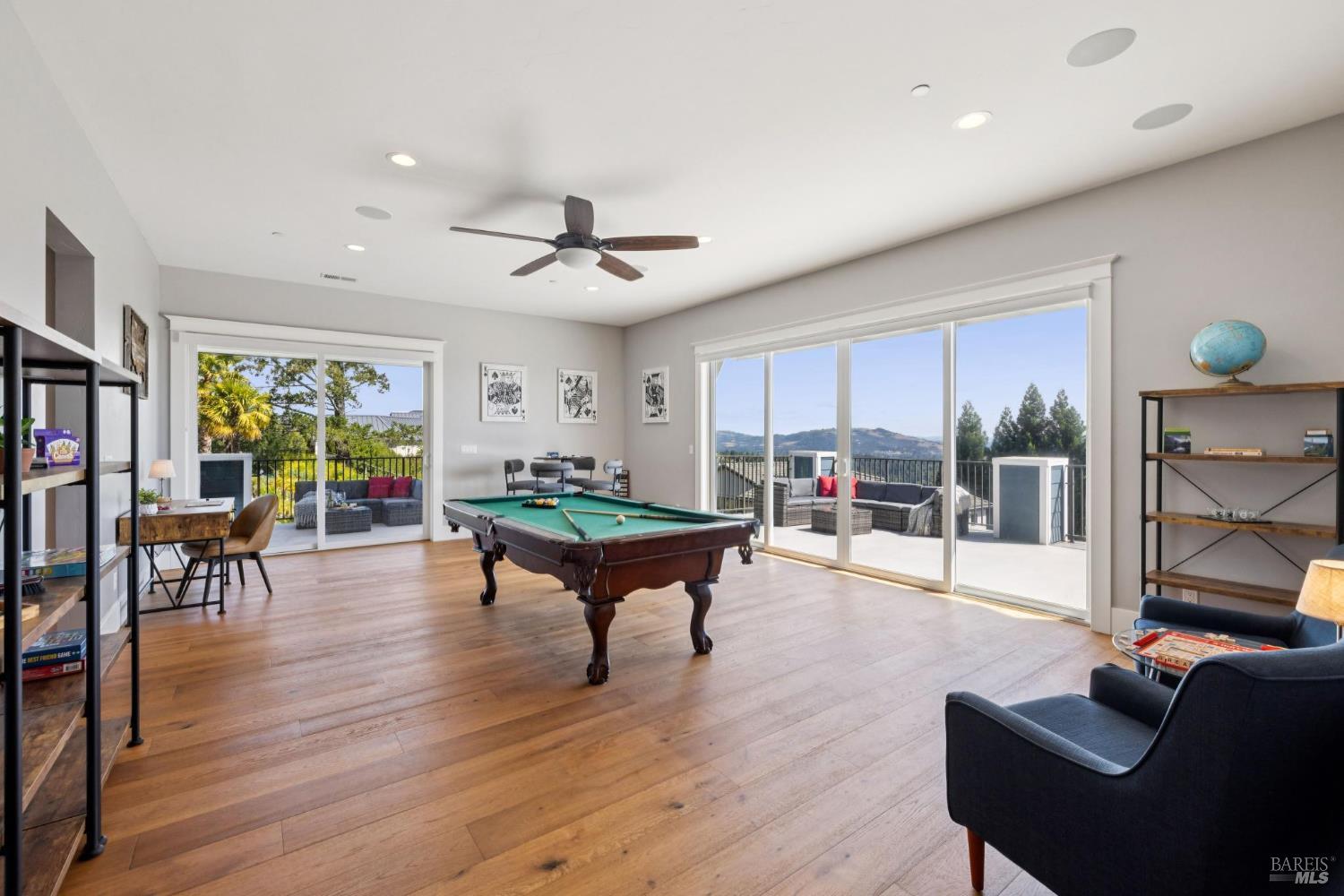 3882 Royal Manor Place Santa Rosa, CA 95404 - Photo 59 of 87 Large game room with sliding glass doors to an open deck and a covered deck for indoor-outdoor living. The builder designed this home to accomodate many different uses. This room has a bedroom and full bathroom to the left that would make this a great guest suite or good for an au pair or caregiver.