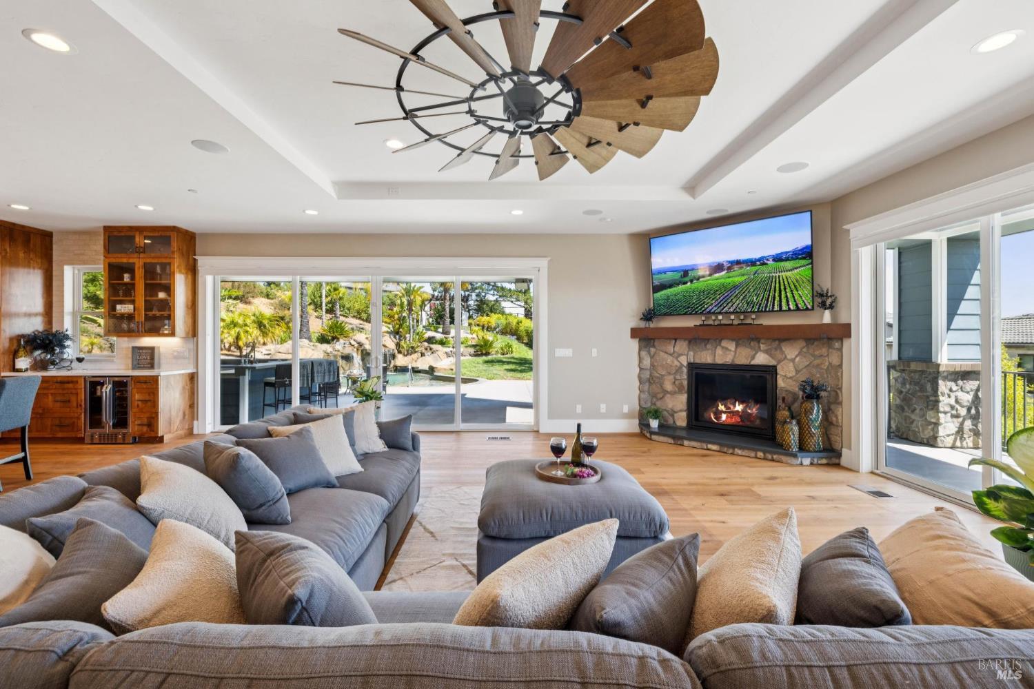 3882 Royal Manor Place Santa Rosa, CA 95404 - Photo 8 of 87 This spacious great room is perfect for entertaining or a quiet day at home. The beautiful oak floors flow seamlessly to the covered patio and outdoor kitchen or to the front porch to enjoy the view toward the sunset and mountains. This room features, hardwood floors, two sliders and gas fireplace. Cook for 2 or 20 in this chef's dream kitchen, featuring 48” Viking range with 6 burners + griddle and two ovens, a separate electric oven for the bakers, a large built-in Sub-Zero refrigerator, and a large built-in Sub-Zero freezer, pot filler, quartz counters, marble backsplash, Viking dishwasher, microwave, Kraus stainless steel sink with custom cutting board, drying rack and drain racks, beautiful customs alder cabinets, recessed lighting, surround sound and more.