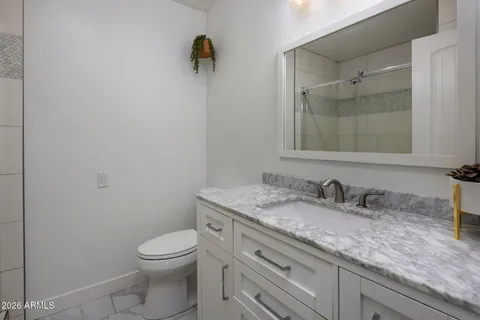 a bathroom with a granite countertop sink mirror and double