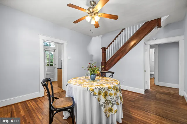 a dining room with furniture and wooden floor