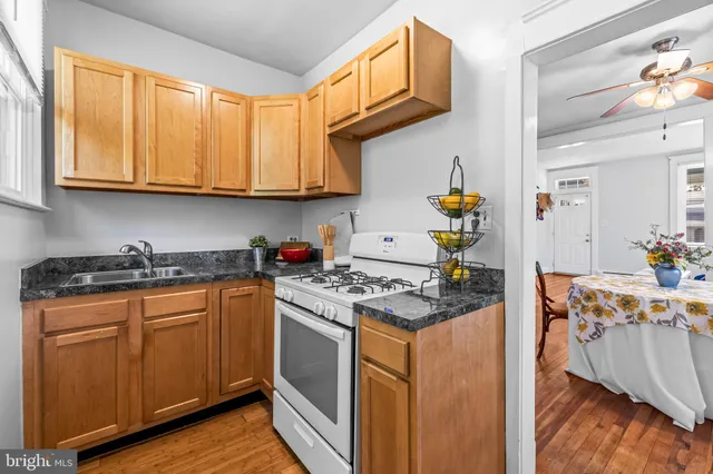 a kitchen with stainless steel appliances granite countertop a stove and a sink