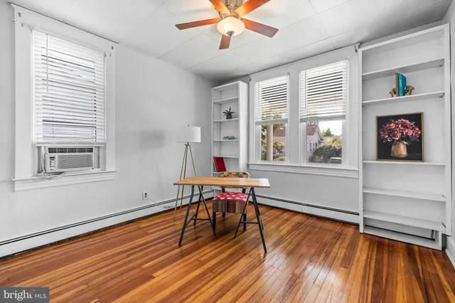 a work room with wooden floor and a window