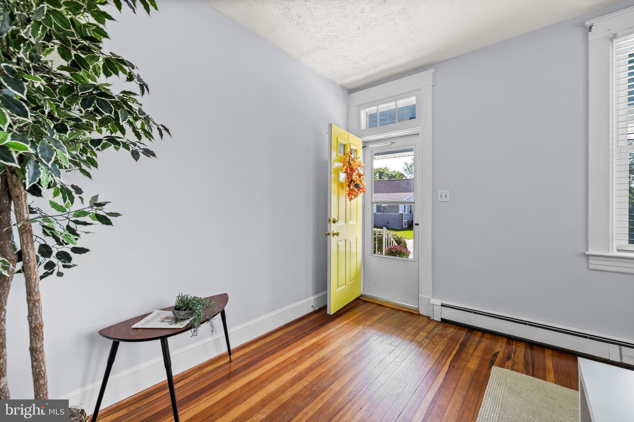 4406 Mainfield Avenue Baltimore, MD 21214 - Photo 4 of 47 a view of a room with wooden floor and potted plant