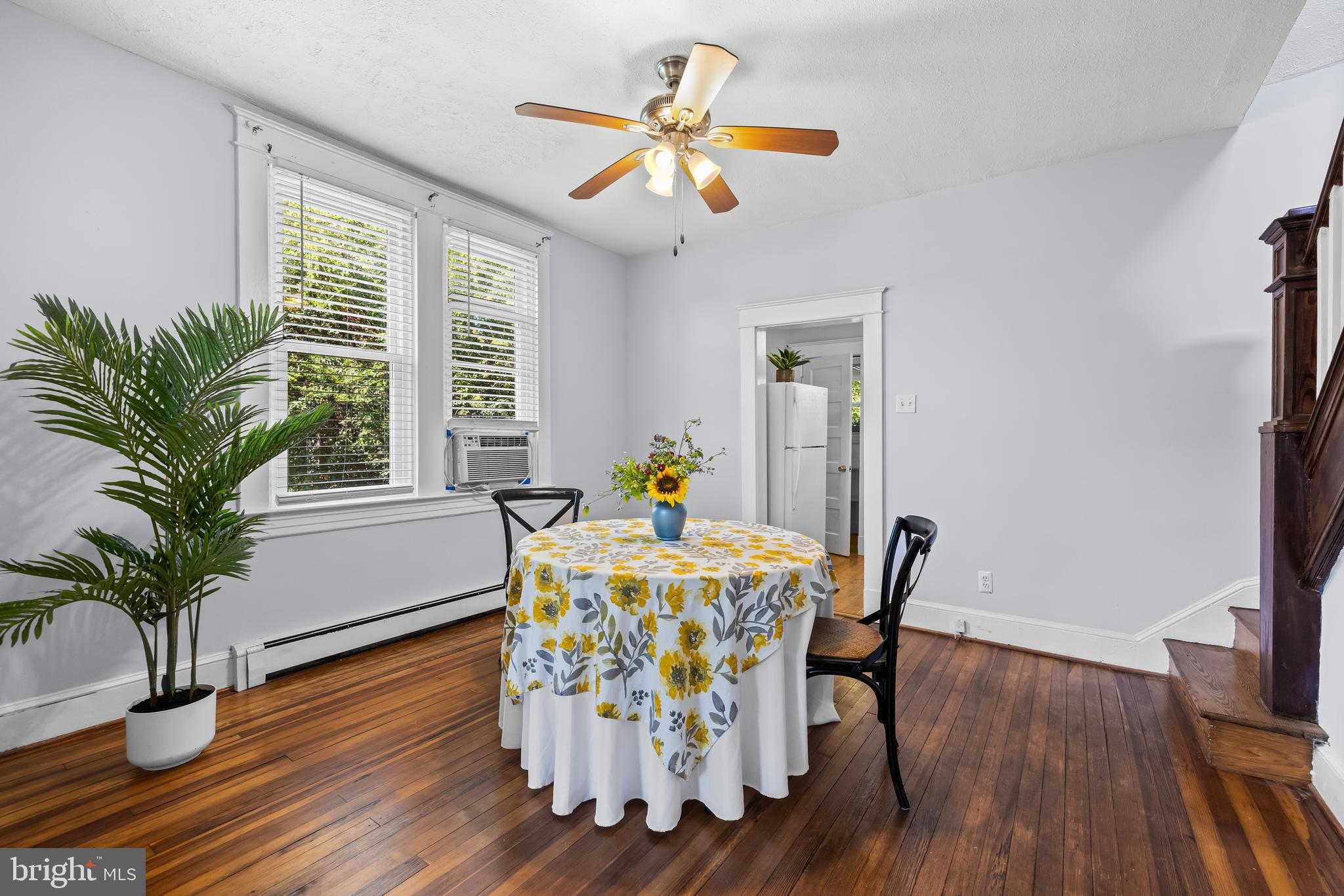 4406 Mainfield Avenue Baltimore, MD 21214 - Photo 9 of 47 a dining room with furniture potted plants and wooden floor