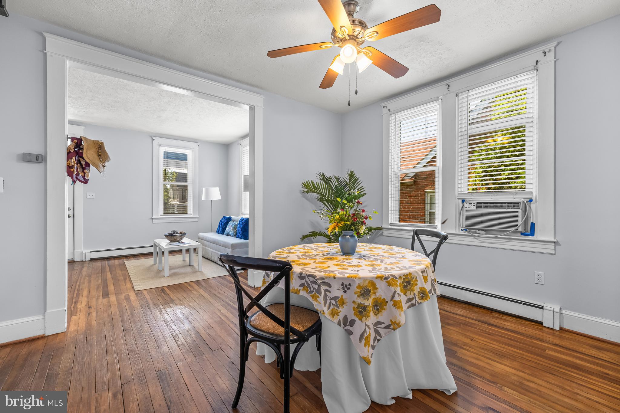 4406 Mainfield Avenue Baltimore, MD 21214 - Photo 10 of 47 a dining room with furniture a chandelier and wooden floor