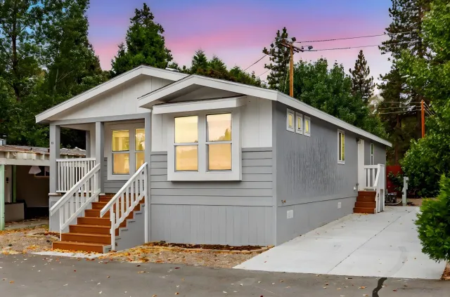 a front view of a house with plants