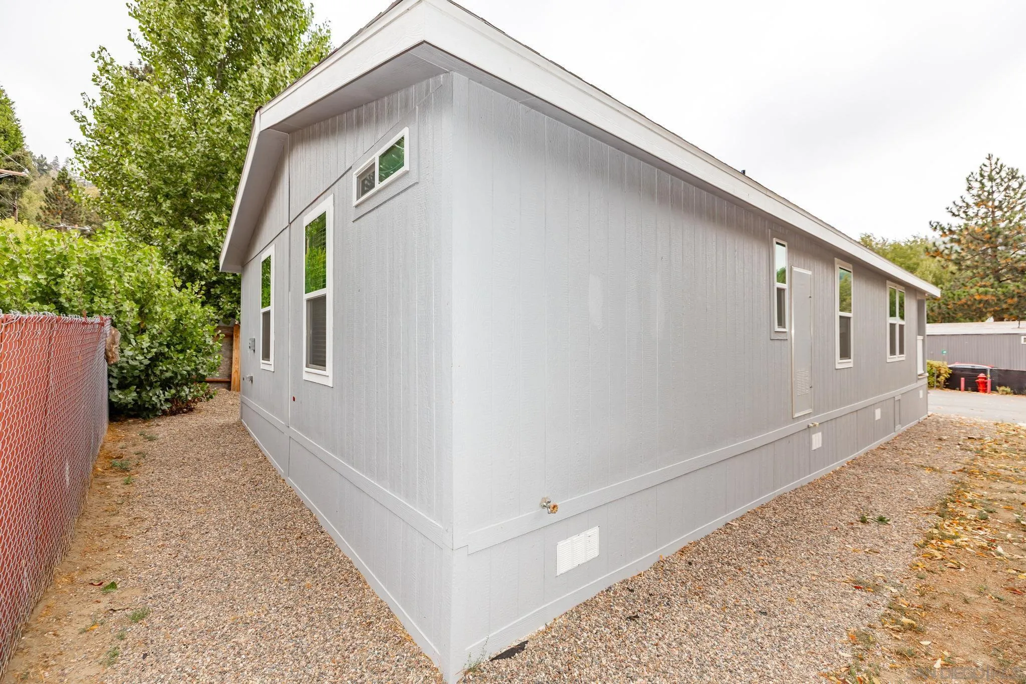 22899 Byron Road, Unit 11 Crestline, CA 92325 - Photo 23 of 25 a front view of a house with wooden fence