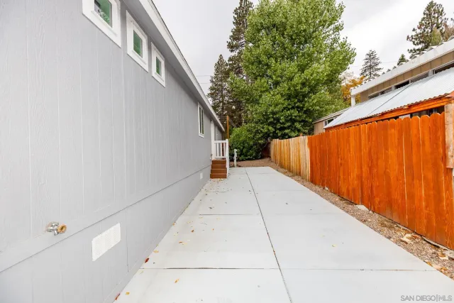 a view of a pathway with a wrought fence