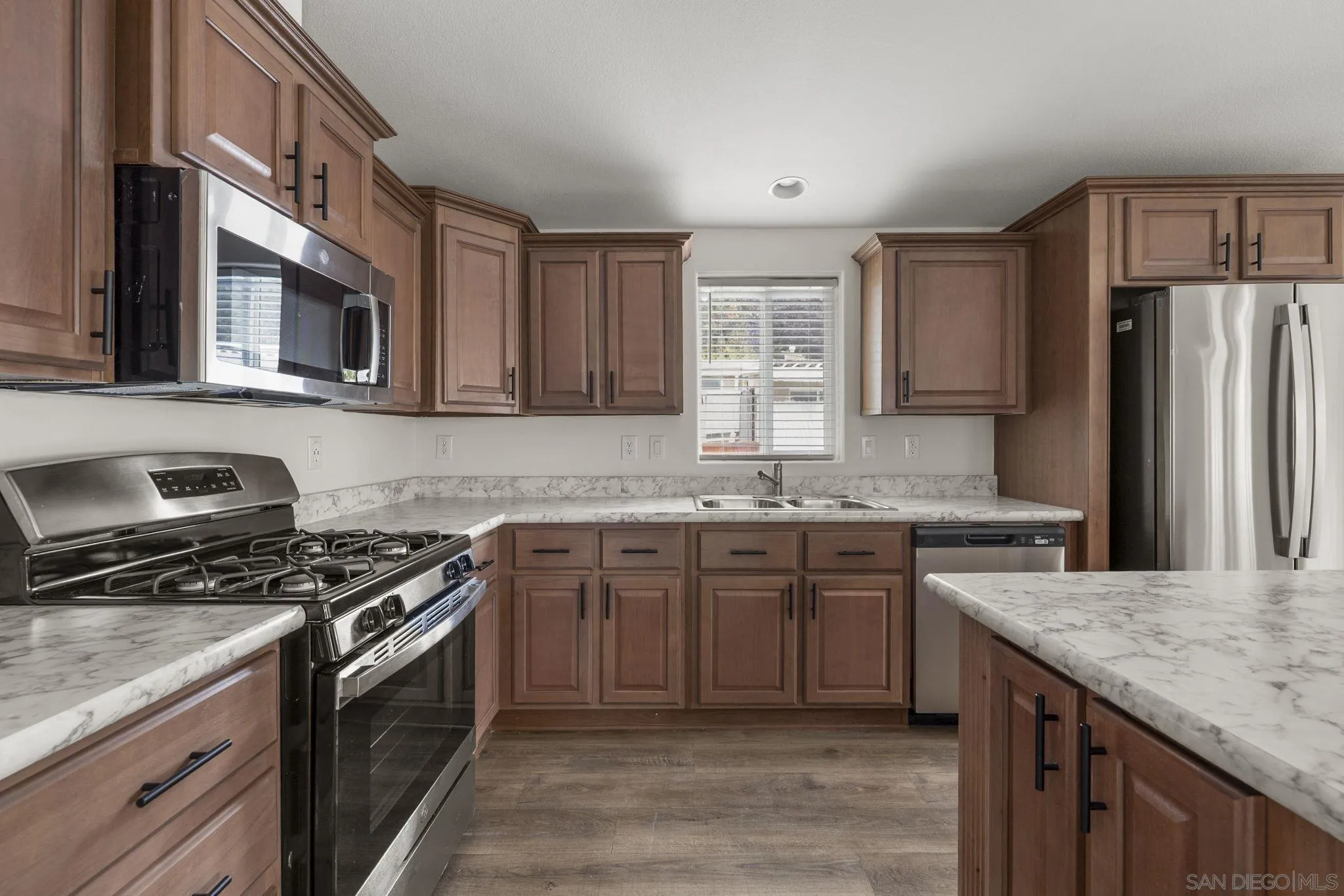 22899 Byron Road, Unit 11 Crestline, CA 92325 - Photo 4 of 25 a kitchen with stainless steel appliances granite countertop a sink stove microwave and refrigerator