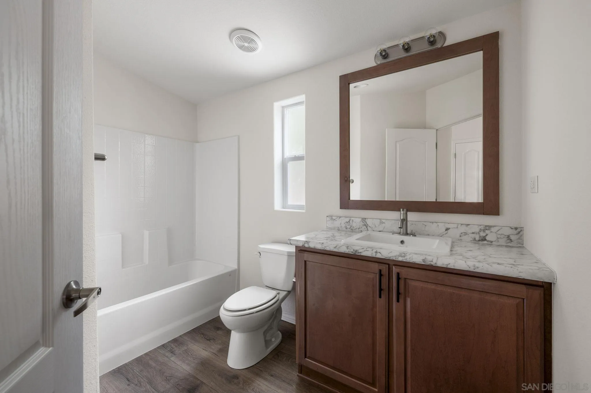22899 Byron Road, Unit 11 Crestline, CA 92325 - Photo 6 of 25 a bathroom with a granite countertop sink toilet and mirror