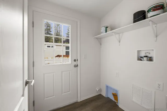 a view of small space with wooden floor and closet
