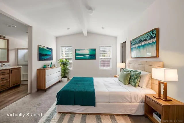 a bedroom with a large bed and a chandelier