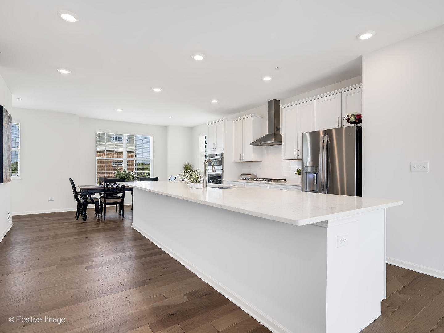 2950 Reflection Drive Naperville, IL 60564 - Photo 14 of 32 a kitchen with stainless steel appliances refrigerator sink dining table and chairs