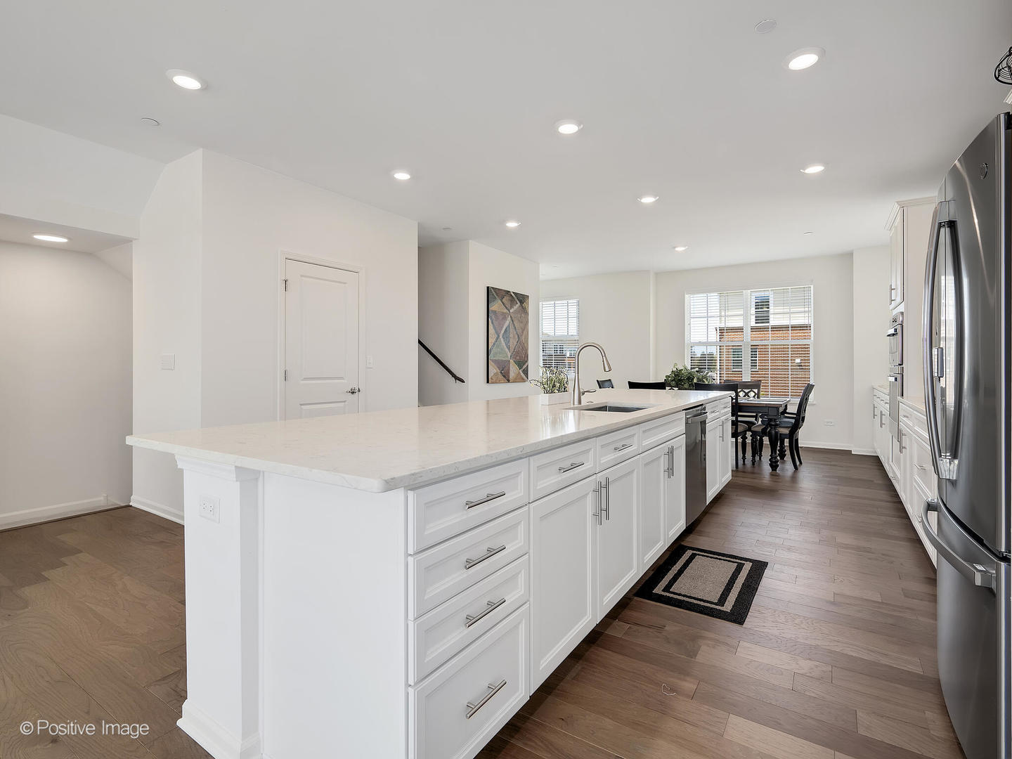 2950 Reflection Drive Naperville, IL 60564 - Photo 15 of 32 a large white kitchen with center island and stainless steel appliances