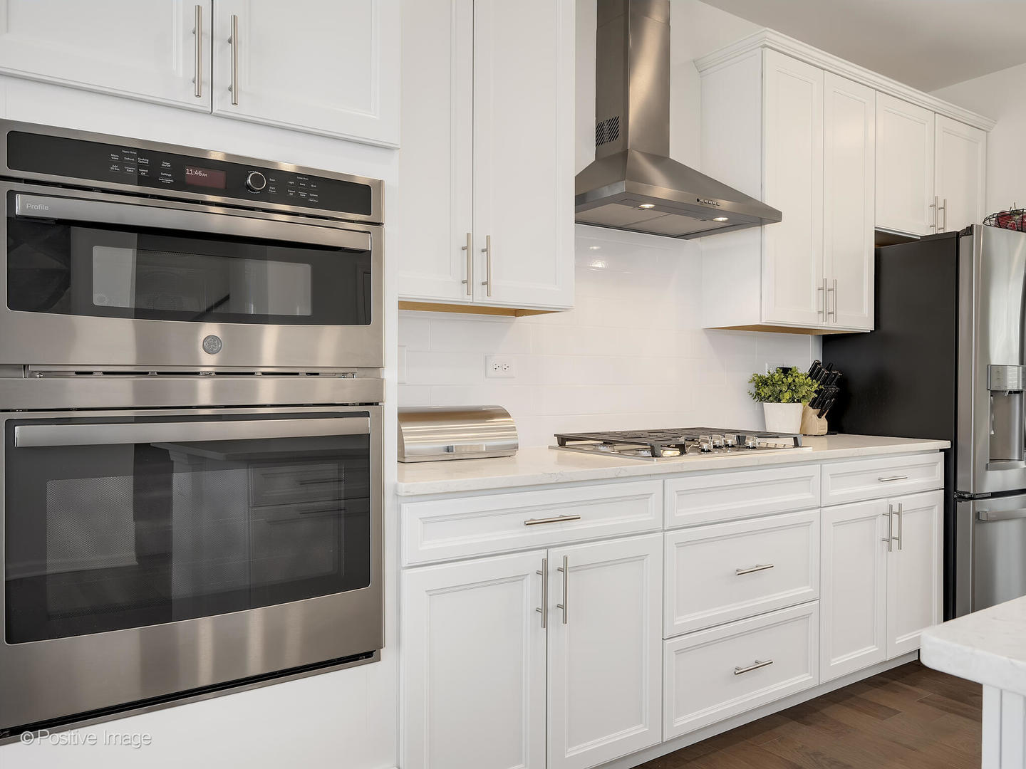 2950 Reflection Drive Naperville, IL 60564 - Photo 17 of 32 a kitchen with white cabinets and stainless steel appliances