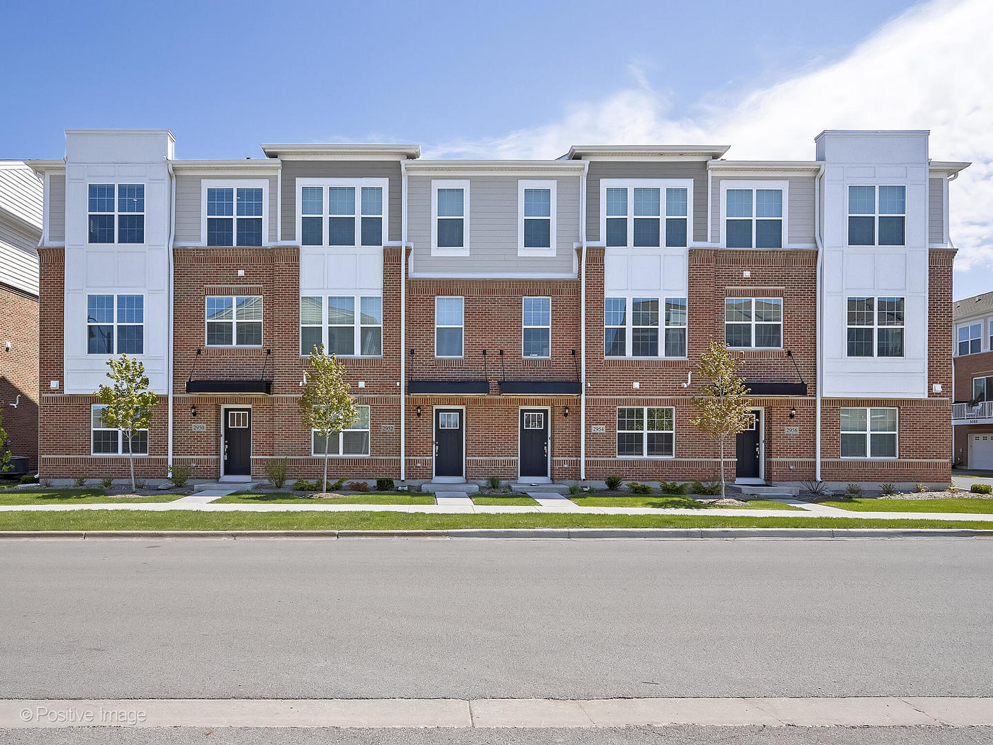 2950 Reflection Drive Naperville, IL 60564 - Photo 2 of 32 a front view of a building with a yard and palm trees