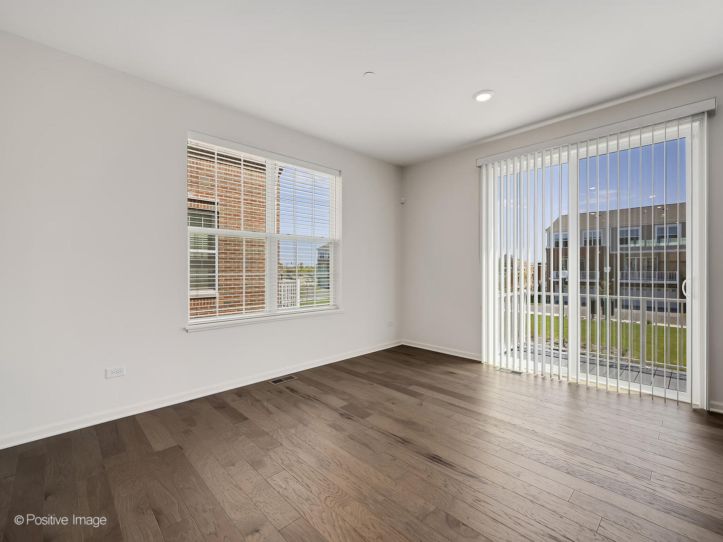 2950 Reflection Drive Naperville, IL 60564 - Photo 9 of 32 a view of an empty room with wooden floor and a window