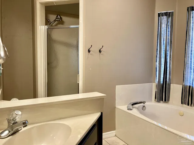 a bathroom with a tub sink and toilet