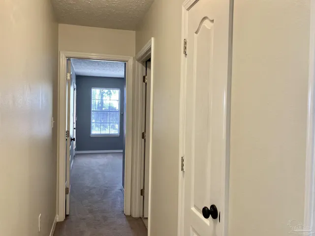 a view of a bathroom from a hallway