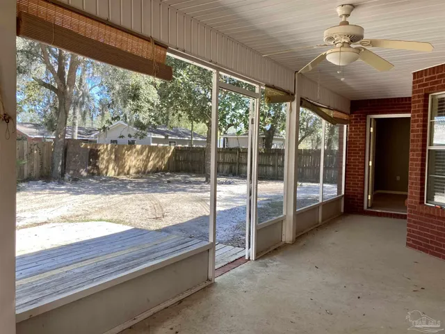 a view of a room with wooden floor and a ceiling fan